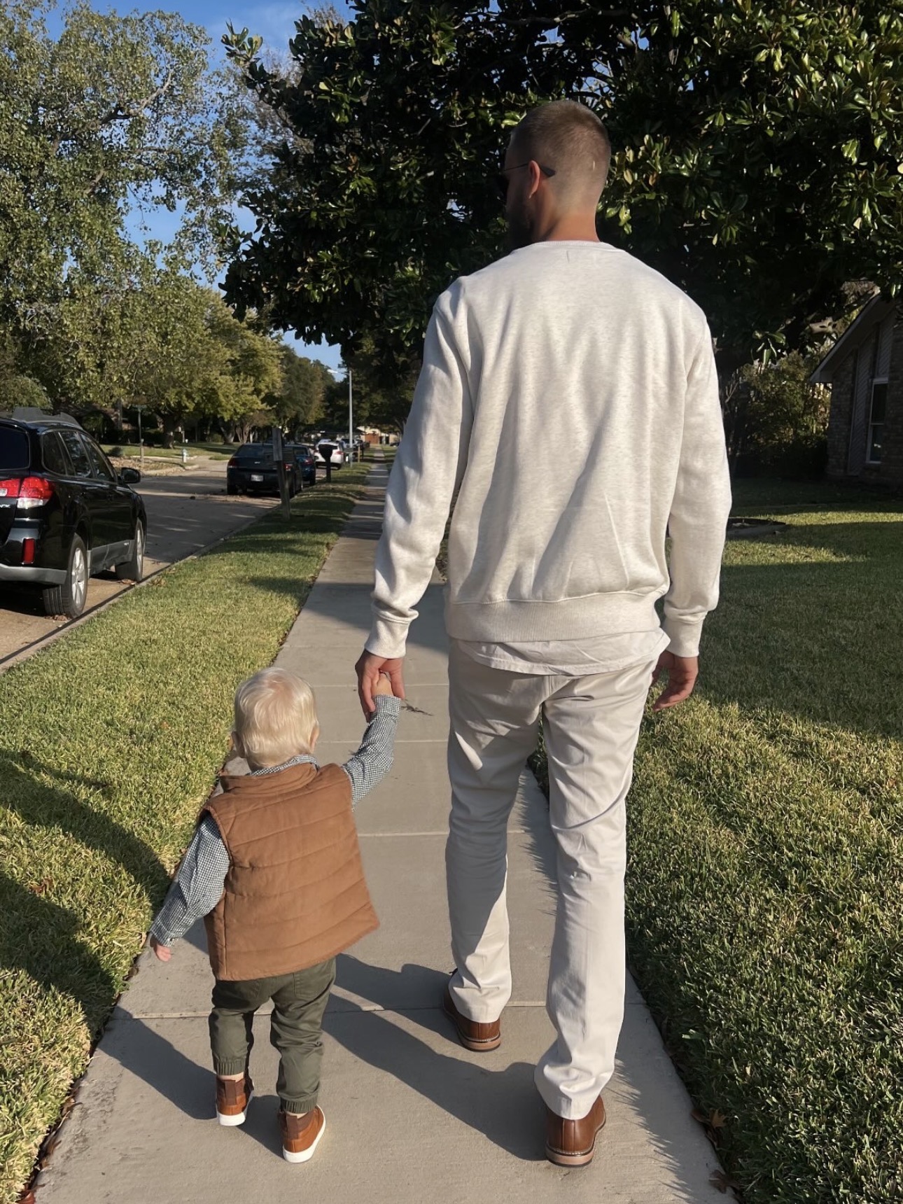 Dillon Hoffman walking with his child through a North Texas neighborhood